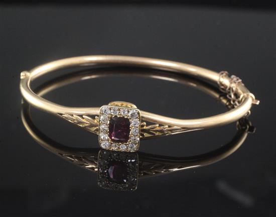 A late Victorian 15ct gold, almandine garnet and diamond set hinged bangle,